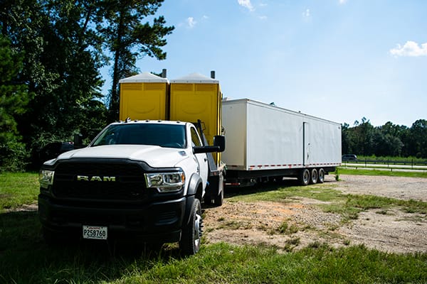 Flat Bed Truck with Porta Potties and a Restroom Trailer